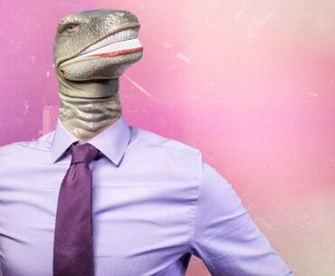 Man wearing pink shirt with dinosaur head