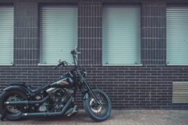 harley davidson brand bike in front of wall