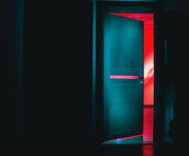 half opened back door in the dark to signify reverse merger of yatra