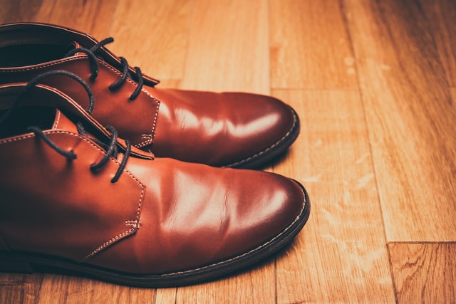 Brown leather shoes on a wooden floor to show bata