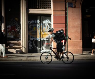 a man on cycle delivering for new kind of e commerce called q commerce